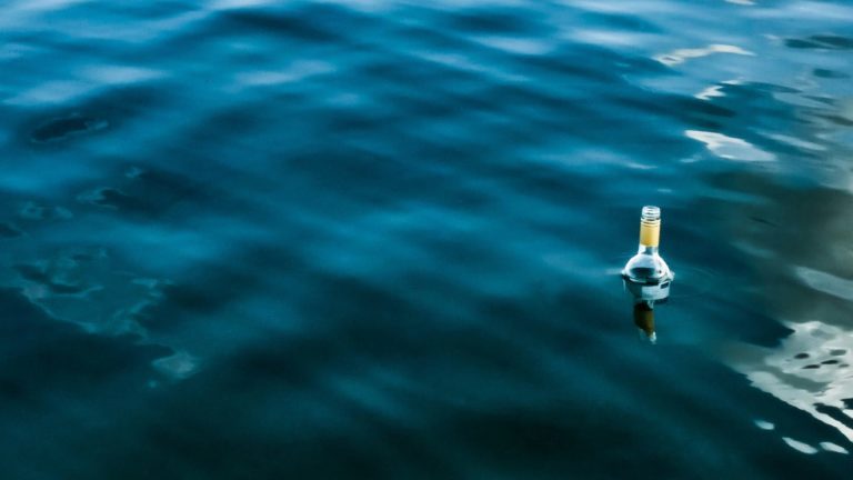 bottle on body of water