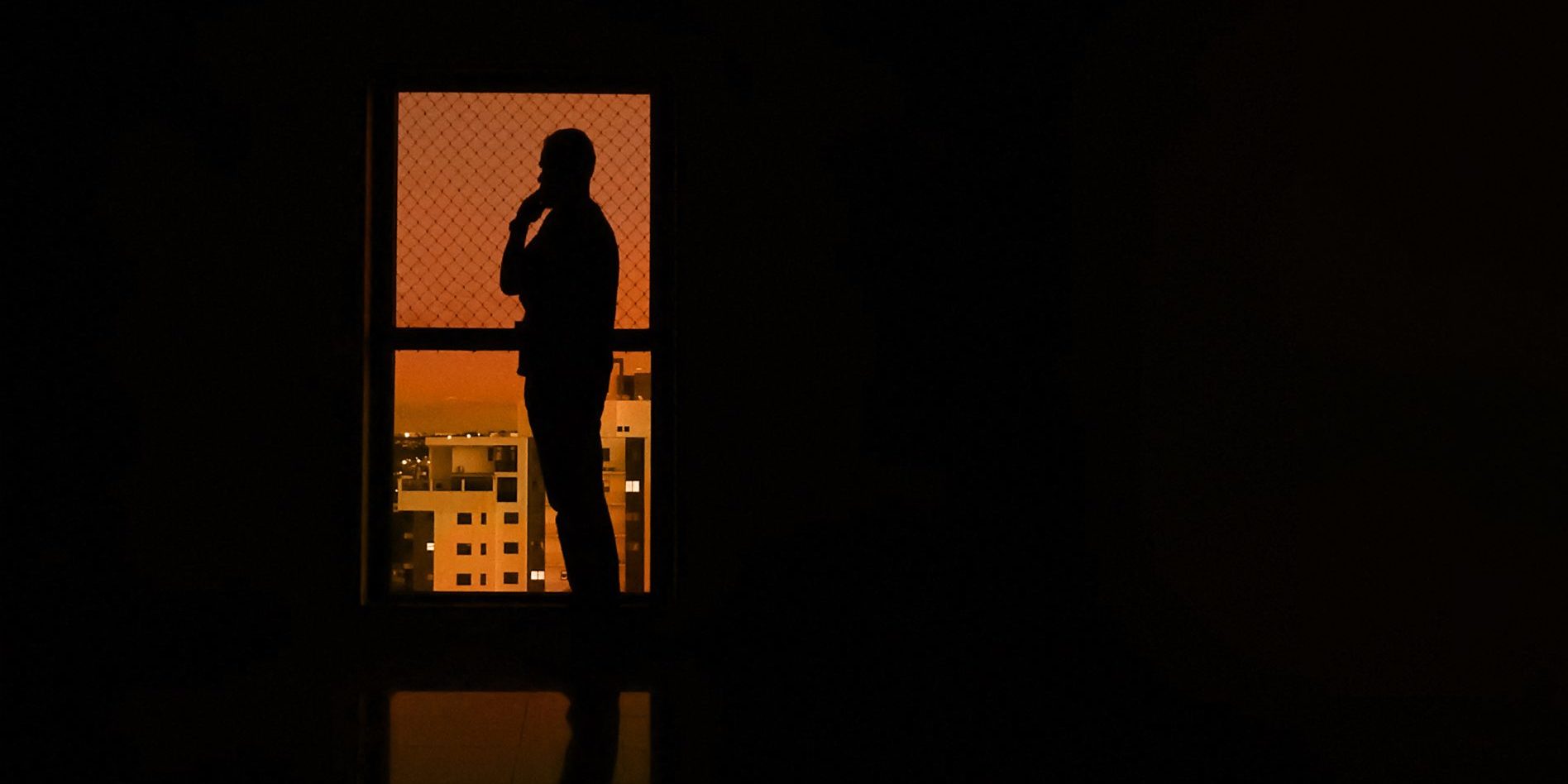 silhouette of woman standing in front of wall