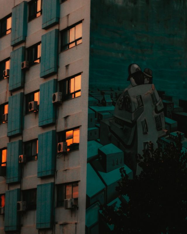 Photo by Nafsika G. man in black jacket standing beside building