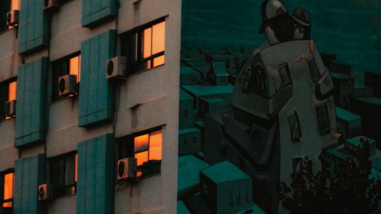 man in black jacket standing beside building