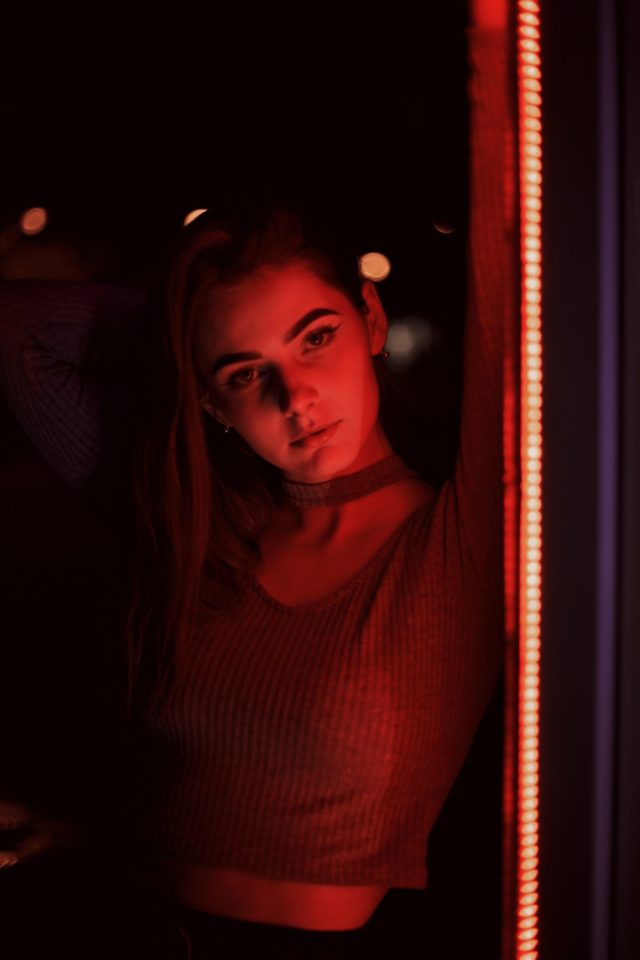 Photo by ilya mondryk woman in red turtleneck shirt