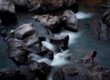 brown rocks on body of water
