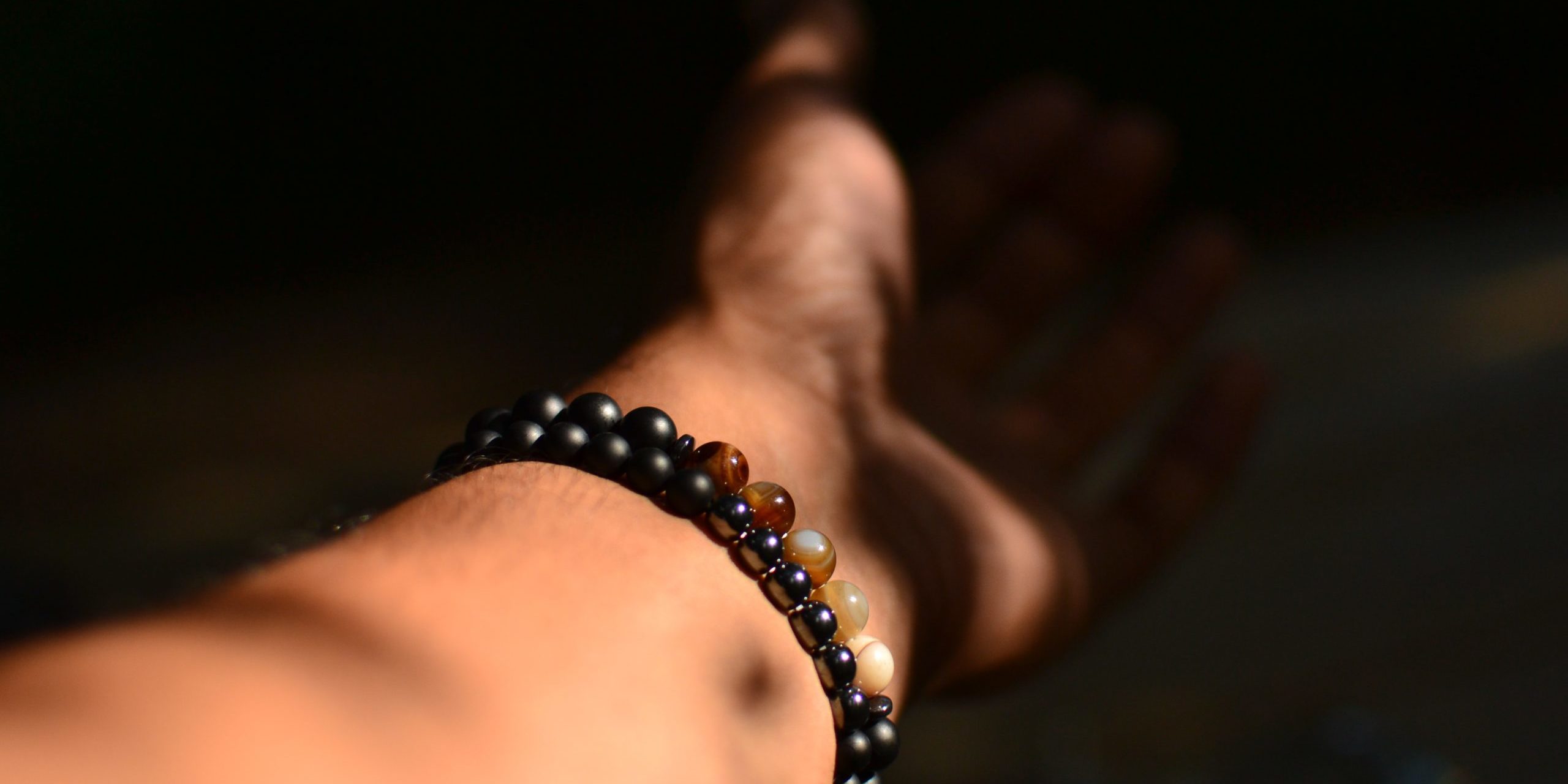 person wearing beaded bracelet