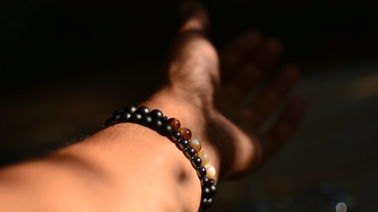person wearing beaded bracelet