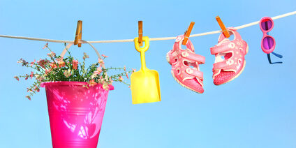 Summer toys and sandals on clothesline