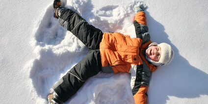 boy lies on north pole snow